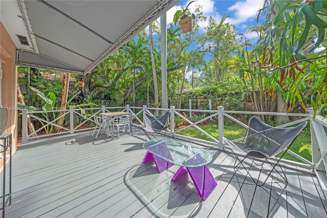 2665 SW 17th Ave, Miami, FL 33133 - wooden deck featuring a fenced backyard, outdoor dining space, and view of wooded area