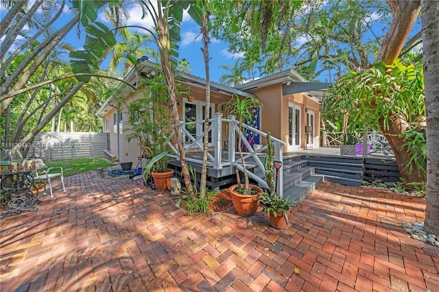 2665 SW 17th Ave, Miami, FL 33133 - view of front of home featuring french doors, a patio area, and a wooden deck
