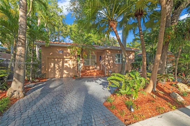 2665 SW 17th Ave, Miami, FL 33133 - view of front facade with decorative driveway and a garage