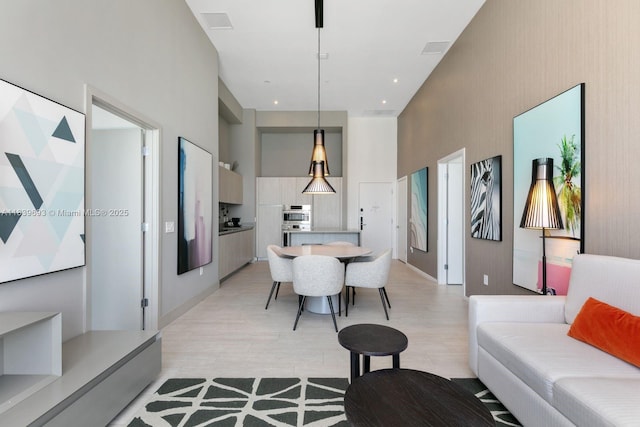 4010 S Ocean Dr Unit T4105, Hollywood, FL 33019 - living area featuring a towering ceiling and light wood finished floors