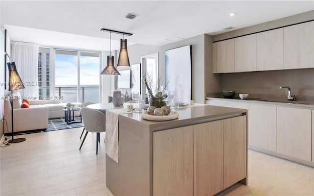4010 S Ocean Dr Unit T4105, Hollywood, FL 33019 - kitchen with modern cabinets, a center island, pendant lighting, light brown cabinetry, and recessed lighting