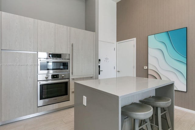 4010 S Ocean Dr Unit T4105, Hollywood, FL 33019 - kitchen featuring double oven, a kitchen breakfast bar, a kitchen island, and light countertops