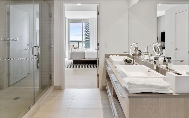 4010 S Ocean Dr Unit T4105, Hollywood, FL 33019 - full bath featuring connected bathroom, double vanity, a stall shower, and tile patterned floors