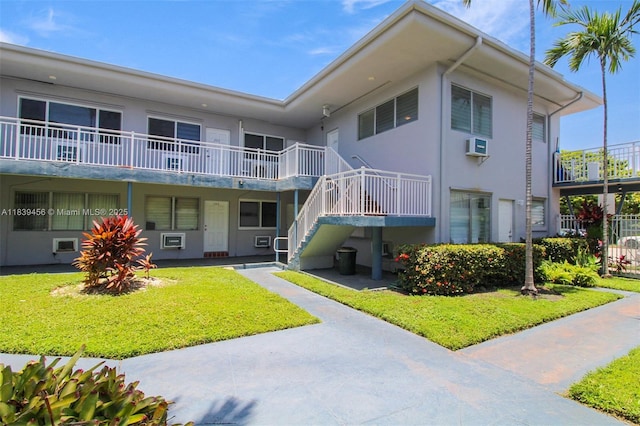 350 75th St Unit 201, Miami Beach, FL 33141 - view of property featuring a wall mounted air conditioner and stairway
