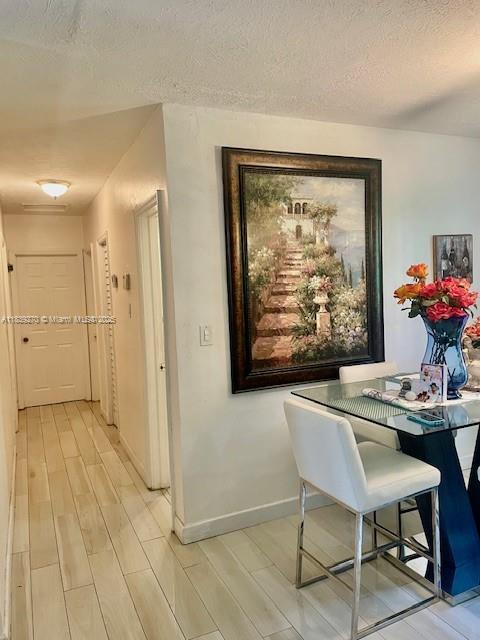 140 NW 199th St, Miami Gardens, FL 33169 - hallway with light wood finished floors and a textured ceiling