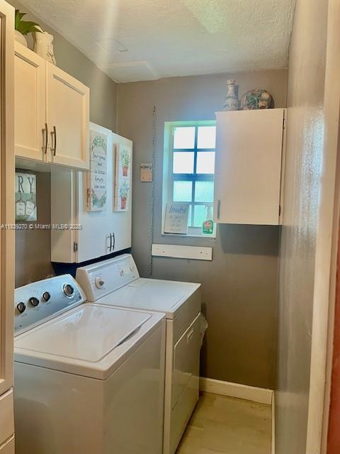 140 NW 199th St, Miami Gardens, FL 33169 - laundry area with cabinet space and washing machine and clothes dryer