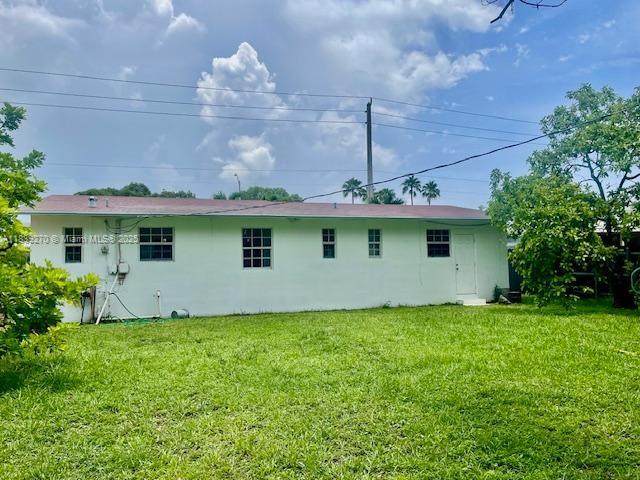 140 NW 199th St, Miami Gardens, FL 33169 - back of house with a yard and stucco siding