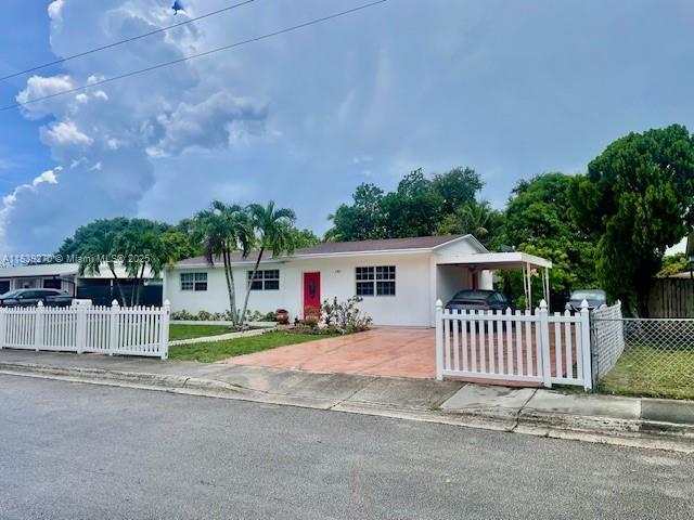 140 NW 199th St, Miami Gardens, FL 33169 - view of front of property with a carport, concrete driveway, and stucco siding