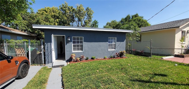 1887 NW 66th St, Miami, FL 33147 - view of front of house with stucco siding and a gate