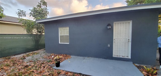 1887 NW 66th St, Miami, FL 33147 - doorway to property featuring a patio and stucco siding