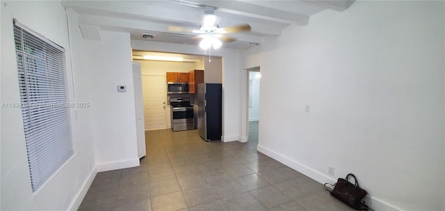 1887 NW 66th St, Miami, FL 33147 - spare room featuring beam ceiling, a ceiling fan, and dark tile patterned floors