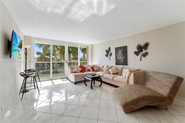 3140 S Ocean Dr Unit 212, Hallandale Beach, FL 33009 - living area with floor to ceiling windows, light tile patterned flooring, and a textured ceiling