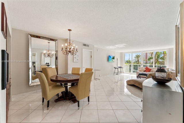 3140 S Ocean Dr Unit 212, Hallandale Beach, FL 33009 - dining room featuring light tile patterned flooring, a chandelier, and a textured ceiling