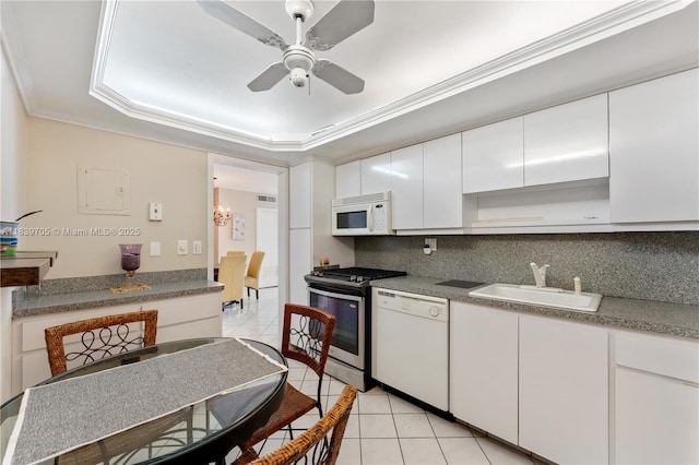 3140 S Ocean Dr Unit 212, Hallandale Beach, FL 33009 - kitchen featuring white appliances, light tile patterned flooring, decorative backsplash, white cabinets, and crown molding