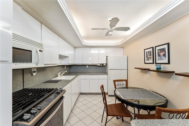 3140 S Ocean Dr Unit 212, Hallandale Beach, FL 33009 - kitchen featuring white appliances, backsplash, white cabinetry, light tile patterned floors, and ceiling fan