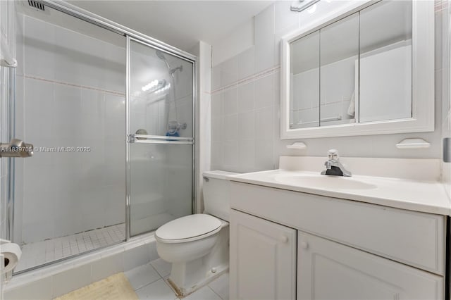 3140 S Ocean Dr Unit 212, Hallandale Beach, FL 33009 - full bathroom with vanity, a stall shower, tile walls, and tile patterned flooring
