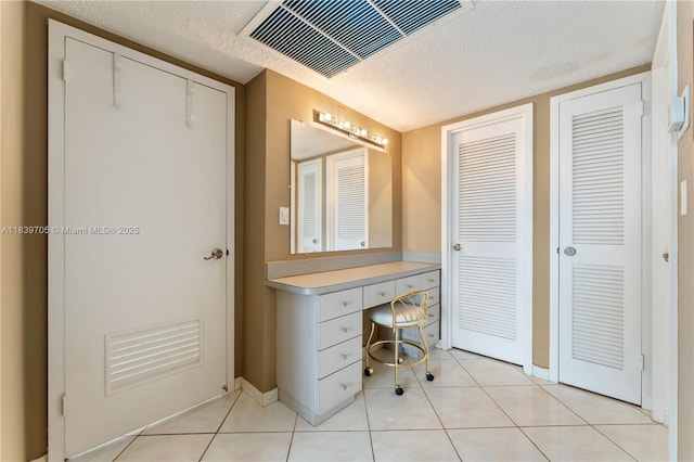 3140 S Ocean Dr Unit 212, Hallandale Beach, FL 33009 - bathroom featuring a textured ceiling, vanity, and tile patterned flooring