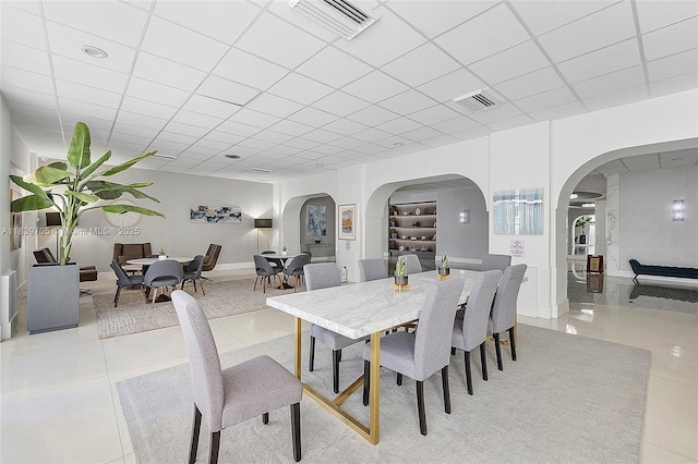 3140 S Ocean Dr Unit 212, Hallandale Beach, FL 33009 - dining space with arched walkways, light tile patterned floors, and a drop ceiling