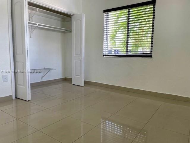 330 W 40th Pl, Hialeah, FL 33012 - unfurnished bedroom with light tile patterned floors and a closet