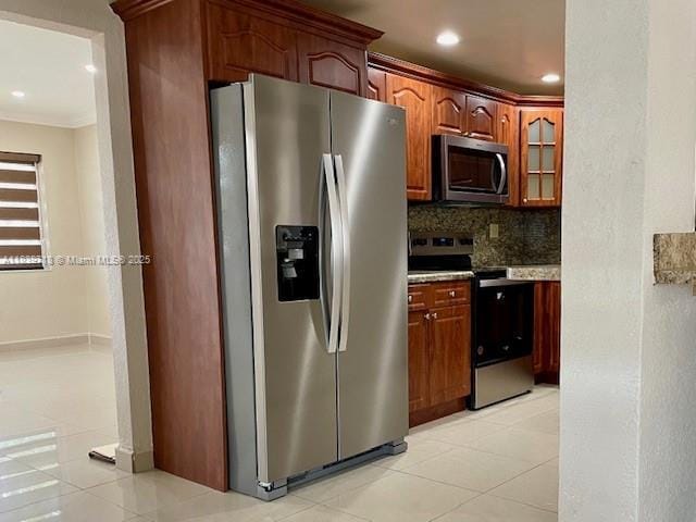 330 W 40th Pl, Hialeah, FL 33012 - kitchen featuring appliances with stainless steel finishes, backsplash, crown molding, light tile patterned flooring, and glass insert cabinets