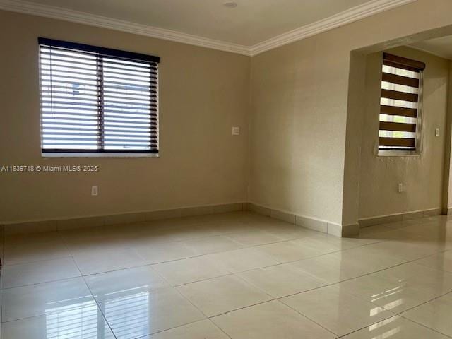 330 W 40th Pl, Hialeah, FL 33012 - empty room with light tile patterned flooring and ornamental molding