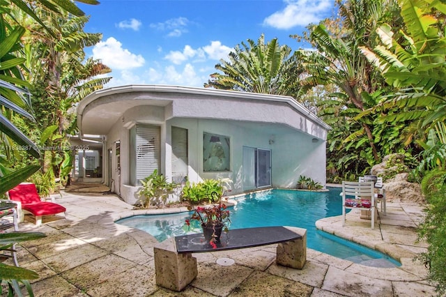 3200 Morris Ln, Miami, FL 33133 - rear view of property with a patio area, an outdoor pool, and stucco siding