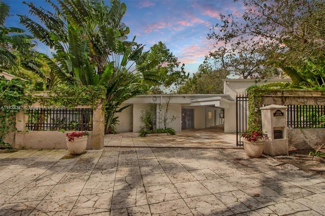 3200 Morris Ln, Miami, FL 33133 - view of front of property with stucco siding, a patio area, and a carport