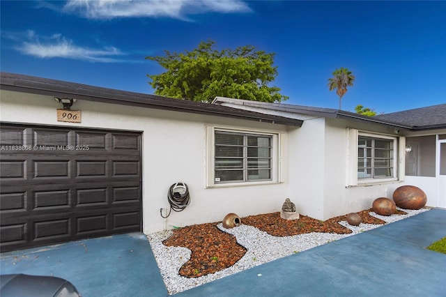 906 Cardinal Pl, Homestead, FL 33035 - view of property exterior with stucco siding, concrete driveway, and an attached garage