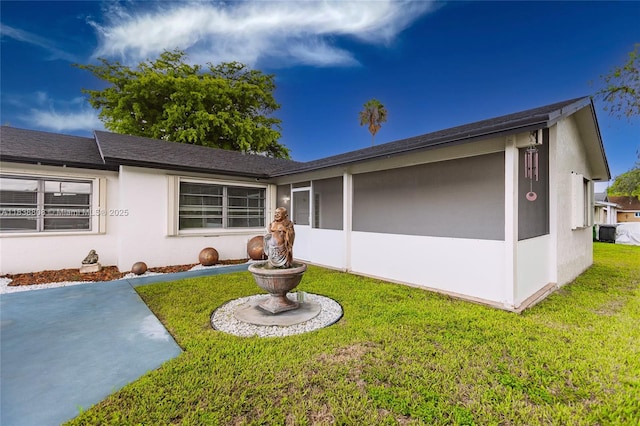 906 Cardinal Pl, Homestead, FL 33035 - back of property with a lawn, stucco siding, and a shingled roof