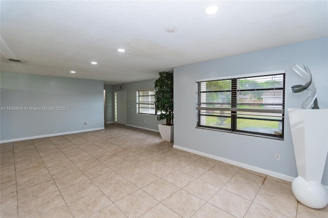906 Cardinal Pl, Homestead, FL 33035 - spare room with a textured ceiling, recessed lighting, and light tile patterned floors
