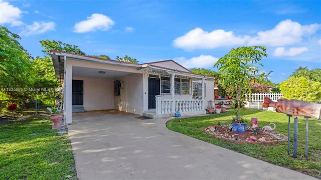 521 SE 5th St, Hialeah, FL 33010 - view of front of property featuring concrete driveway, an attached carport, and stucco siding