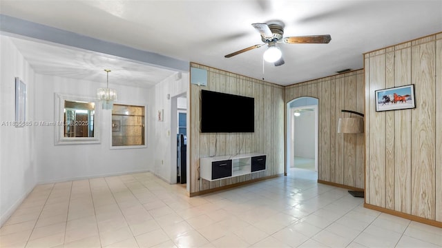 521 SE 5th St, Hialeah, FL 33010 - unfurnished living room with a ceiling fan, arched walkways, a chandelier, and wood walls