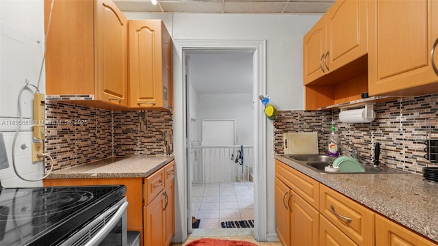521 SE 5th St, Hialeah, FL 33010 - kitchen featuring tasteful backsplash, light tile patterned floors, electric range, and light countertops