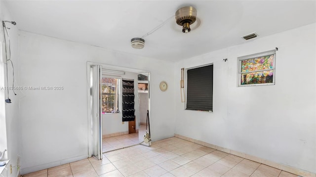 521 SE 5th St, Hialeah, FL 33010 - empty room with baseboards and light tile patterned floors