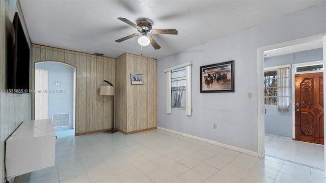 521 SE 5th St, Hialeah, FL 33010 - spare room featuring ceiling fan, arched walkways, and wood walls