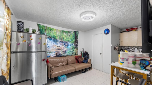 521 SE 5th St, Hialeah, FL 33010 - kitchen with freestanding refrigerator, a textured ceiling, and tasteful backsplash