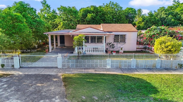 521 SE 5th St, Hialeah, FL 33010 - view of front of home featuring a fenced front yard, stucco siding, and a porch
