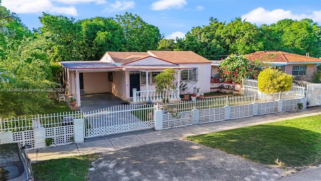 521 SE 5th St, Hialeah, FL 33010 - view of front of house with a fenced front yard, covered porch, stucco siding, and a gate