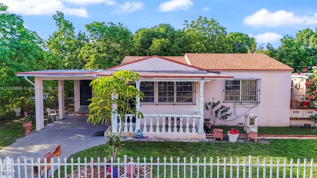 521 SE 5th St, Hialeah, FL 33010 - view of front facade featuring a fenced front yard, concrete driveway, stucco siding, and a carport