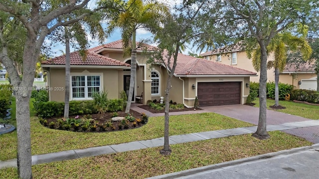 19252 N Hibiscus St, Weston, FL 33332 - mediterranean / spanish home featuring a garage, decorative driveway, a tiled roof, stucco siding, and a front yard