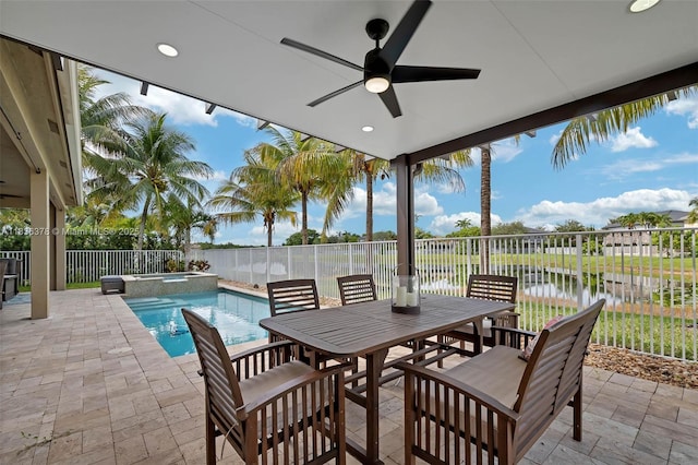 19252 N Hibiscus St, Weston, FL 33332 - fenced backyard featuring a patio area, a ceiling fan, a pool with connected hot tub, outdoor dining space, and a water view