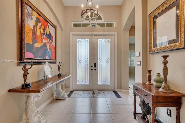 19252 N Hibiscus St, Weston, FL 33332 - tiled foyer entrance with arched walkways, a chandelier, and french doors