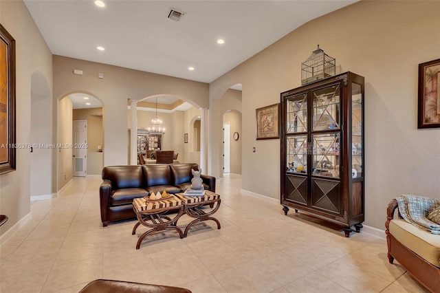 19252 N Hibiscus St, Weston, FL 33332 - living room featuring arched walkways, light tile patterned floors, recessed lighting, ornate columns, and a chandelier