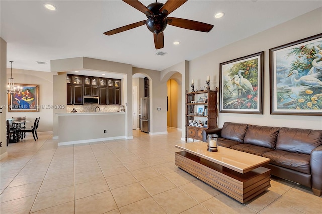 19252 N Hibiscus St, Weston, FL 33332 - living room with arched walkways, recessed lighting, a ceiling fan, light tile patterned flooring, and a chandelier