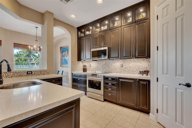 19252 N Hibiscus St, Weston, FL 33332 - kitchen featuring a chandelier, light tile patterned flooring, backsplash, appliances with stainless steel finishes, and recessed lighting