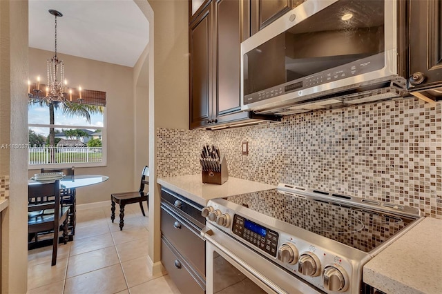 19252 N Hibiscus St, Weston, FL 33332 - kitchen with stainless steel appliances, dark brown cabinetry, and a chandelier