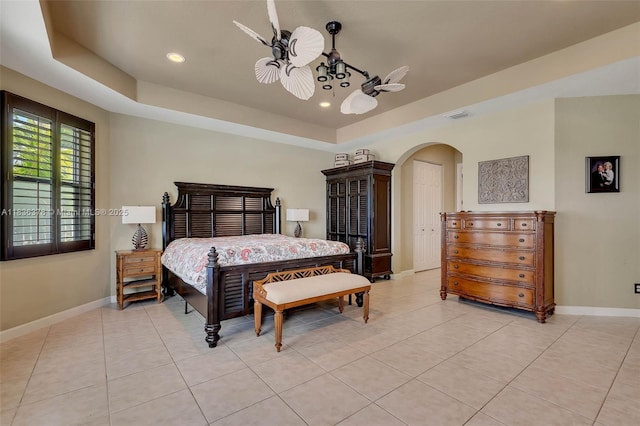 19252 N Hibiscus St, Weston, FL 33332 - bedroom with arched walkways, a tray ceiling, light tile patterned floors, recessed lighting, and ceiling fan