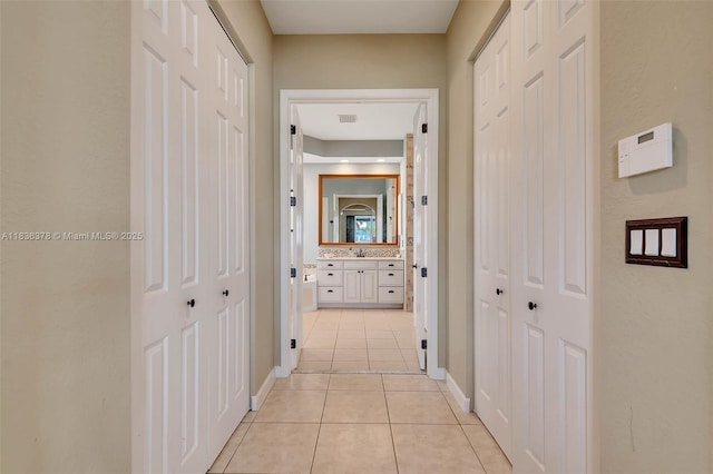 19252 N Hibiscus St, Weston, FL 33332 - hallway with light tile patterned flooring and baseboards