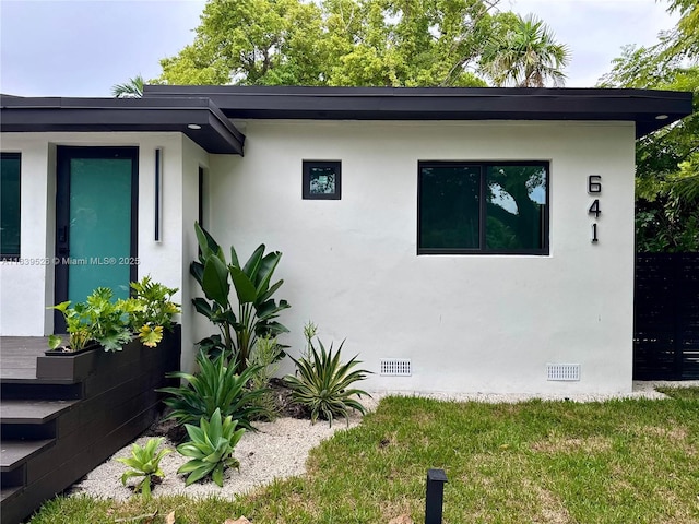 641 Nightingale Ave, Miami Springs, FL 33166 - view of side of home featuring stucco siding and crawl space