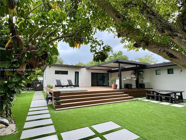 641 Nightingale Ave, Miami Springs, FL 33166 - back of property with stucco siding, a lawn, and a wooden deck